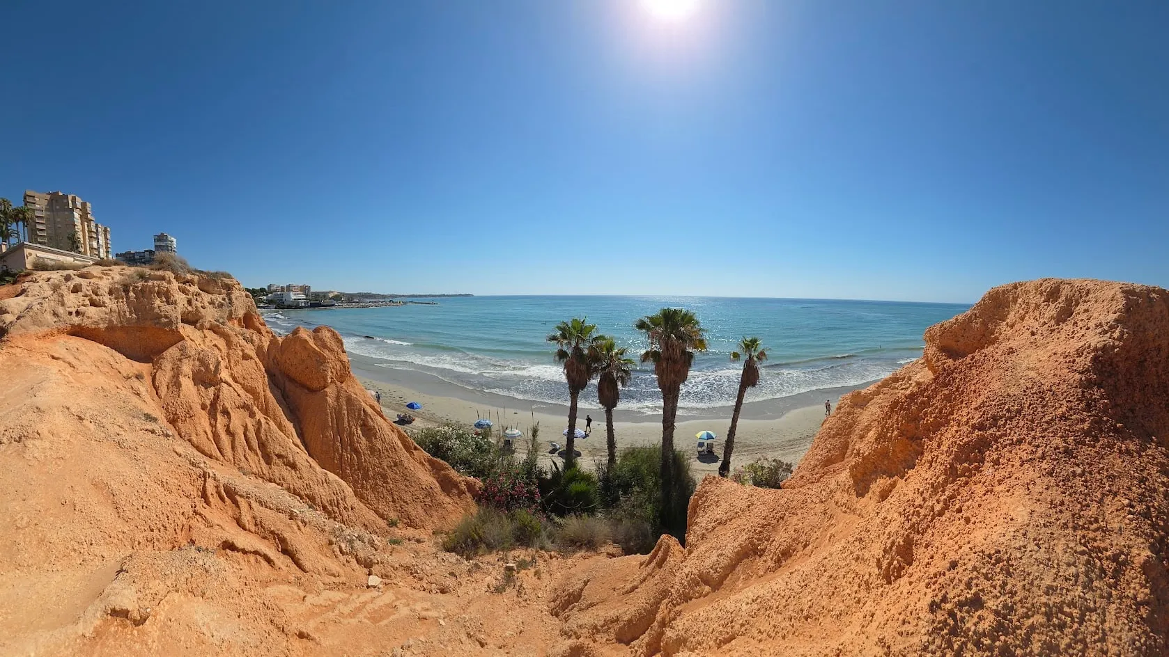 Playa de Campoamor backed by reddish cliffs, also known as Barranco Rubio